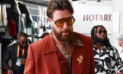 Travis Kelce Flaunts His Chest Hair in '70s-Inspired Suit with Massive Gold Brooch and Aviators...