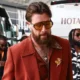 Travis Kelce Flaunts His Chest Hair in '70s-Inspired Suit with Massive Gold Brooch and Aviators...