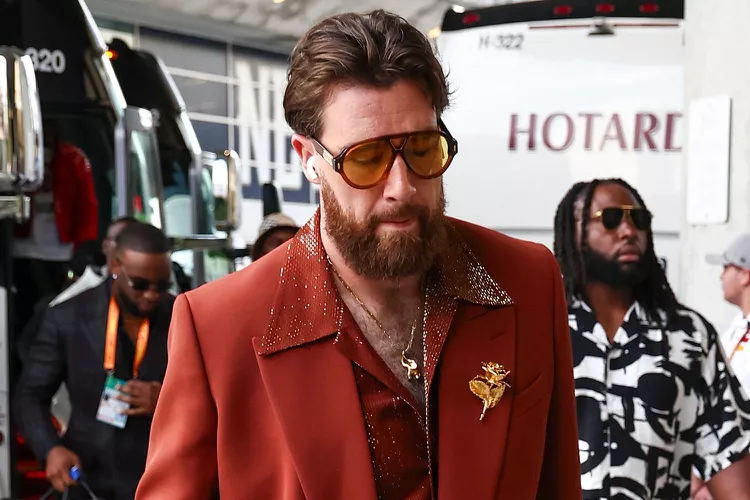 Travis Kelce Flaunts His Chest Hair in '70s-Inspired Suit with Massive Gold Brooch and Aviators...